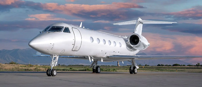 Beautiful Gulfstream GIV parked in an airport with the sunset