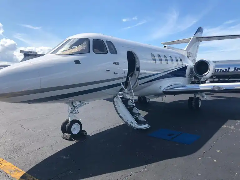 White private airplane with blue strips