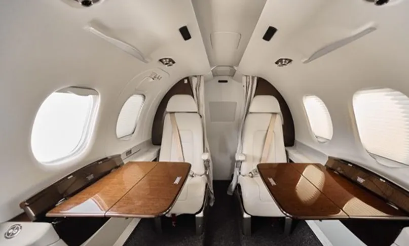 Interior layout with table with tables set up Embraer Phenom 100EV