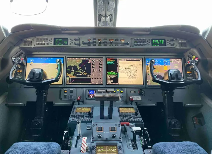 The advanced flight deck of the Gulfstream G550, showcasing the complete Honeywell Epic Enhanced avionics suite with four main display units lit up.