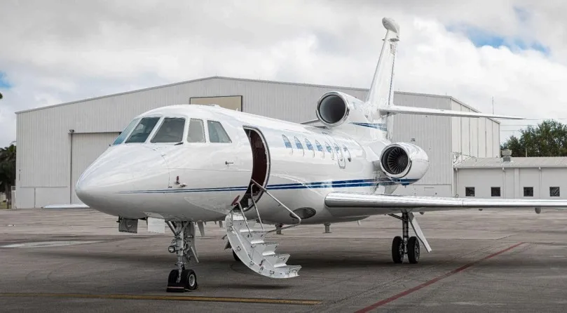 Inviting view of the 2002 Falcon 50EX exterior with the airstair deployed, ready for passenger boarding