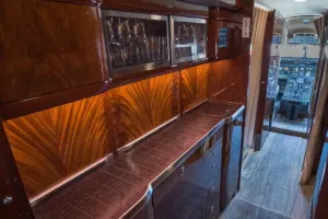 Fully equipped forward galley of Bombardier Global XRS S/N 9234 with dark wood cabinetry and custom lighting