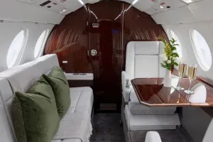 The comfortable aft cabin of the Falcon 50EX, featuring a three-place divan opposite a club seating and conference group