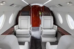 View of the forward cabin of the Falcon 50EX, showing the four-place club seating arrangement with luxurious white leather seats