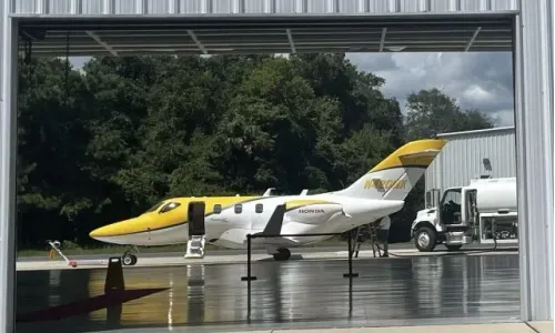 Honda HA-420 HondaJet parking front a hangar