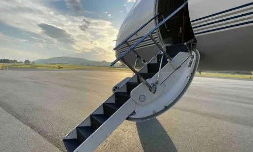 View looking up the airstairs into the welcoming cabin of the Gulfstream G550, showcasing the easy and private boarding process.