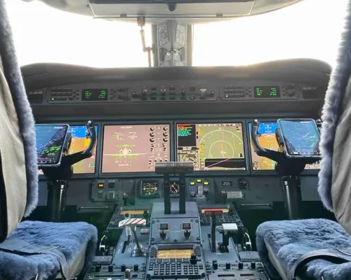 Pilot's perspective of the modern Gulfstream G550 cockpit, including the main instrument panel and side-mounted electronic flight bag (EFB) tablets.