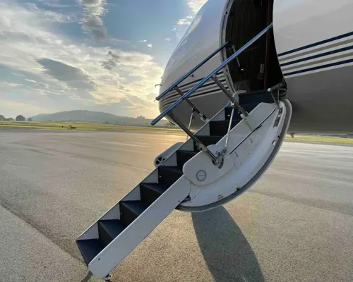 View looking up the airstairs into the welcoming cabin of the Gulfstream G550, showcasing the easy and private boarding process.